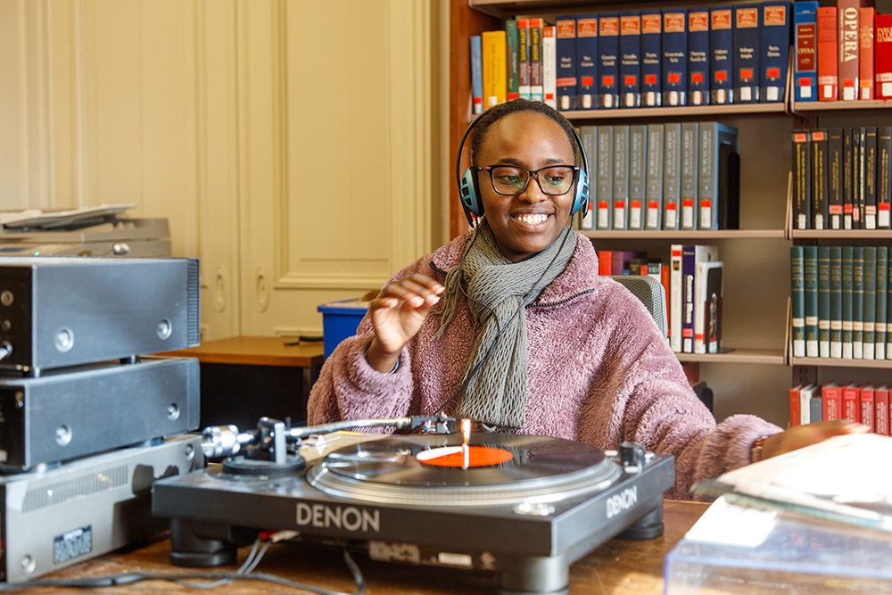 Student listens to an album from the Music Collection on one of the library's LP players.